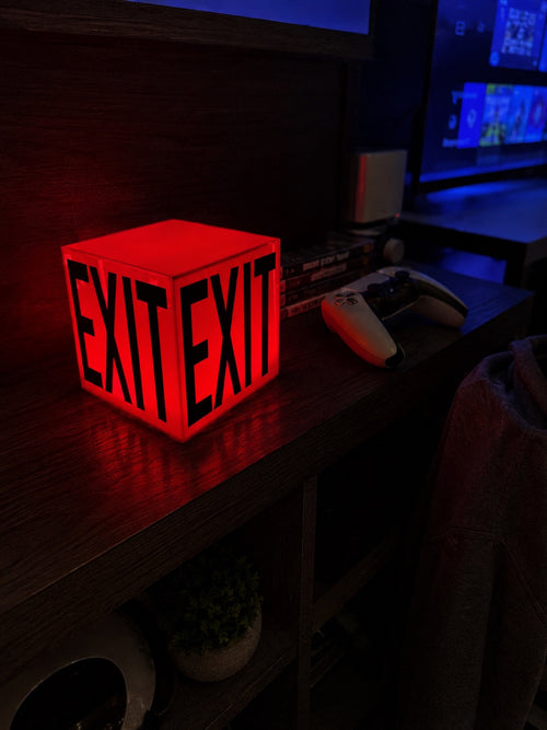 Cube Lamp - EXIT Red - lifestyle photo glowing red on desk