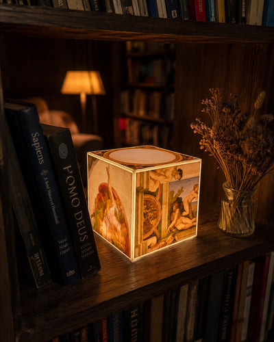 Cube Lamp - The Creation of Adam - lifestyle photo on a bookshelf