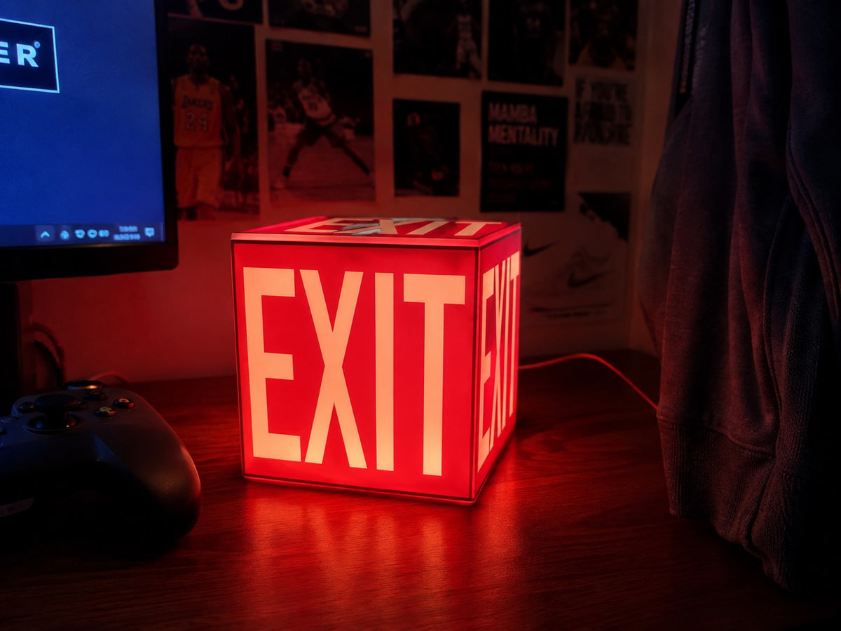 Cube Lamp - EXIT Red - lifestyle photo on a gaming desk with posters